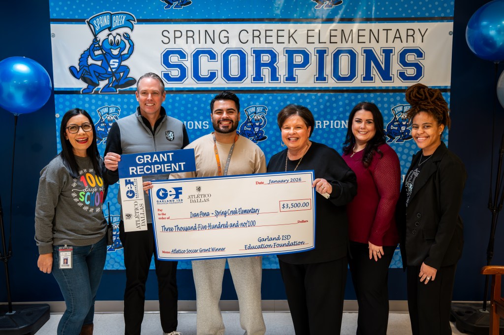Leaders from Atlético Dallas and Garland ISD Education Foundation present a large check to grant recipients at Spring Creek Elementary